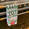 Kitchen towel with keyboard design hanging on oven.